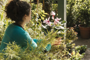 side-view-woman-holding-flower-pot